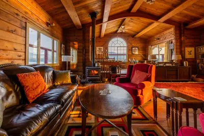 a living room with a couch and a table at Alert Bay Lodge in Alert Bay