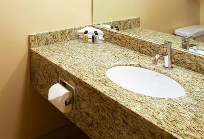 a bathroom counter with a sink and a mirror at Century Casino & Hotel Edmonton in Edmonton
