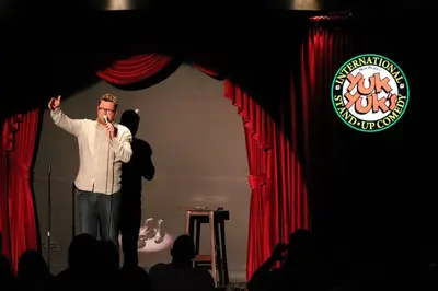 a man standing on a stage holding a microphone at Century Casino & Hotel Edmonton in Edmonton