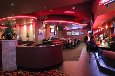 a restaurant with a bar and people sitting at tables at Century Casino & Hotel Edmonton in Edmonton
