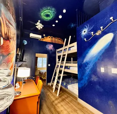 a room with a bunk bed and a bedroom with a mural at Super 8 by Wyndham Castlegar BC in Castlegar
