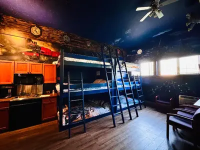 a room with four bunk beds in a kitchen at Super 8 by Wyndham Castlegar BC in Castlegar