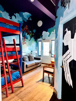 a room with a bedroom with a mural of clouds at Super 8 by Wyndham Castlegar BC in Castlegar