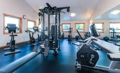 a gym with several treadmills and exercise machines at Best Western Plus Tin Wis Resort in Tofino