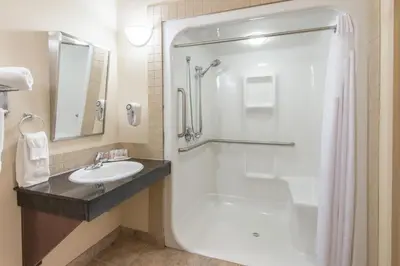 a bathroom with a shower and a sink at Ramada by Wyndham Wainwright in Wainwright