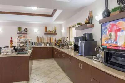 a fast food restaurant with a large counter with at Ramada by Wyndham Wainwright in Wainwright