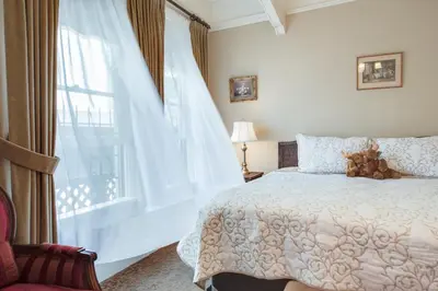a bedroom with a bed and a large window at O Canada House Bed & Breakfast in Vancouver