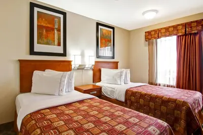 a hotel room with two beds and a window at Canalta Rocky Mountain House in Rocky Mountain House