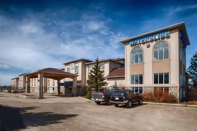 a large building with a truck parked in a parking lot at Canalta Rocky Mountain House in Rocky Mountain House