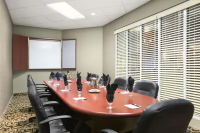 a conference room with a long table and chairs at Travelodge by Wyndham Strathmore in Strathmore