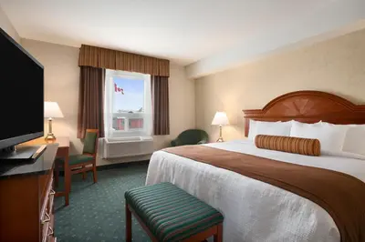 a hotel room with a large bed and a window at Travelodge by Wyndham Strathmore in Strathmore