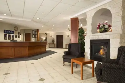 a lobby with a fireplace and a waiting room at Travelodge by Wyndham Strathmore in Strathmore