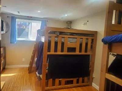 a room with two bunk beds and a window at The Calgary Hub hostel style Home in Calgary