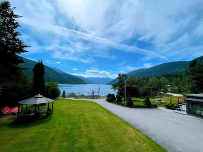 a large park with a view of a lake and mountains at Kokanee Glacier Resort in Nelson