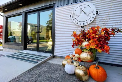 a clock on the side of a building with pumpkins at Kokanee Glacier Resort in Nelson