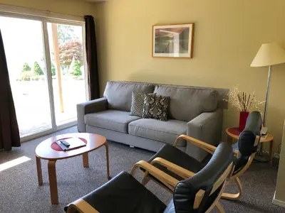 a living room with a couch and chairs and a table at Kokanee Glacier Resort in Nelson