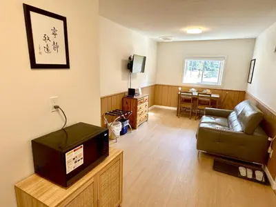 a living room with a couch and a television at Richca Chalets Resort in Hope