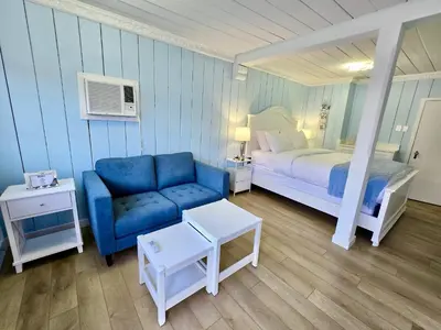a bedroom with a blue couch and a bed at Richca Chalets Resort in Hope