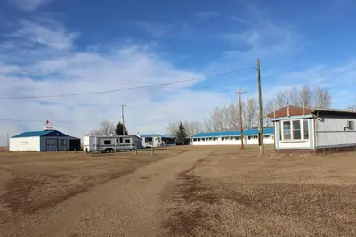 a dirt road with buildings and a dirt field at Raval Paradise Motel and RV Park in Youngstown