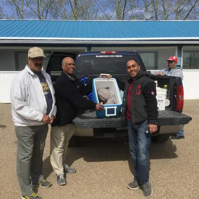a group of three men standing next to a truck at Raval Paradise Motel and RV Park in Youngstown