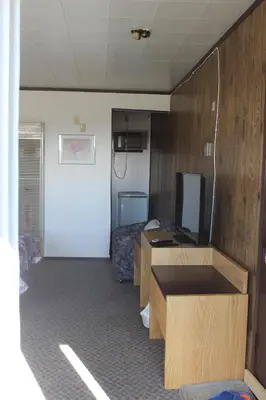 a room with two desks and a tv in a room at Raval Paradise Motel and RV Park in Youngstown