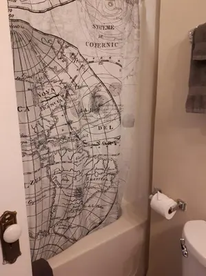 a bathroom with a map on the shower curtain at Marketa's Bed and Breakfast in Victoria