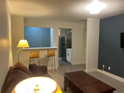 a living room with a couch and a kitchen at Rimbey Motor Inn in Rimbey