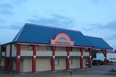 a building with a sign on top of it at Deer Park Inn in Red Deer