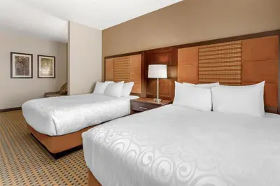 two beds in a hotel room with two beds sidx sidx sidx at Best Western Plus Hinton Inn & Suites in Hinton