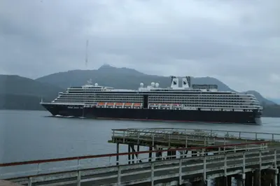 a cruise ship in the water with a dock at Nimpkish Hotel in Alert Bay