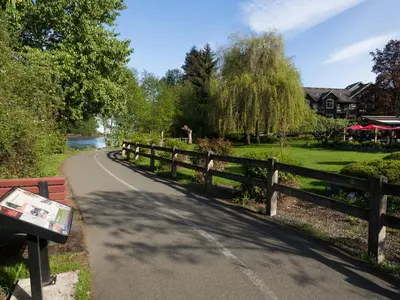 a winding road next to a fence next to a park at Old House Hotel in Courtenay