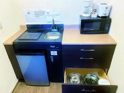 a kitchen with a sink and a washing machine at Grande Mountain Lodge in Grande Cache