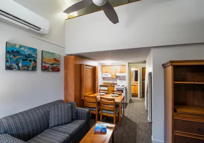 a living room with a couch and a table at Whistler Village Inn & Suites in Whistler
