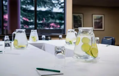 a table with a vase with lemon slices in it at Whistler Village Inn & Suites in Whistler