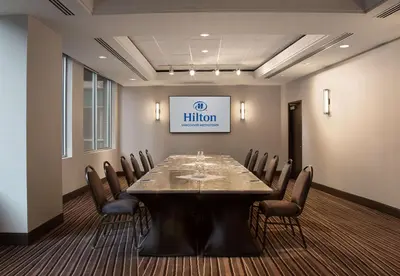 a conference room with a long table and chairs at Hilton Vancouver Metrotown in Burnaby