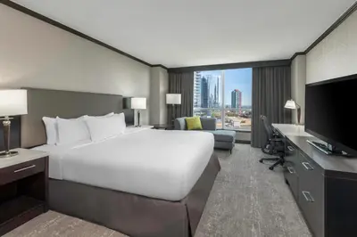 a hotel room with a large bed and a television at Hilton Vancouver Metrotown in Burnaby