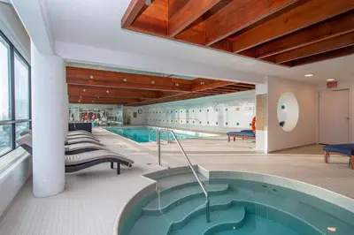 a pool in a building with a swimming pool at Sandman Signature Edmonton Downtown Hotel in Edmonton