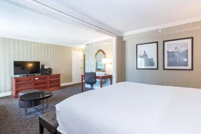 a hotel room with a bed and a desk and a television at Sandman Signature Edmonton Downtown Hotel in Edmonton