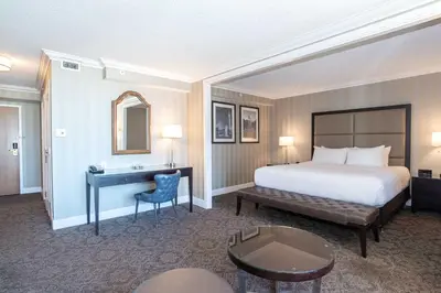 a hotel room with a bed and a desk at Sandman Signature Edmonton Downtown Hotel in Edmonton