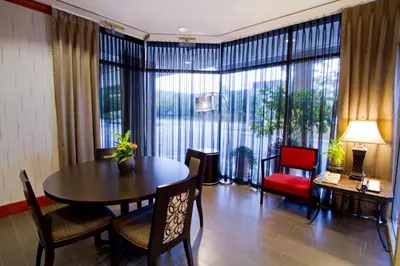 a living room with a table and chairs and a large window at Hampton Inn - Vancouver Airport/Richmond in Richmond