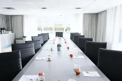 a long table in a conference room with chairs at Hampton Inn & Suites, by Hilton - Vancouver Downtown in Vancouver