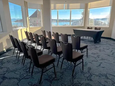 a conference room with chairs and a table and windows at Coast Bastion Hotel in Nanaimo