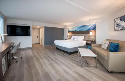 a hotel room with a bed and a couch at Coast Bastion Hotel in Nanaimo