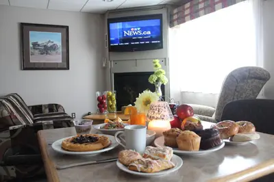a table with a bunch of pastries on it at Travelodge by Wyndham Fort McMurray in Fort McMurray