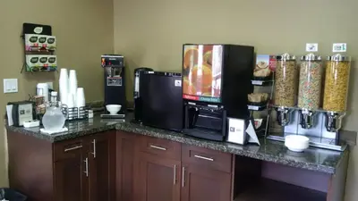 a kitchen with a counter with a microwave and a coffee maker at Sigma Inn & Suites Hudson's Hope in Hudson Hope
