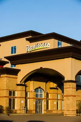 a building with a ritzenstein sign on the front at Radisson Hotel & Suites Fort McMurray in Fort McMurray