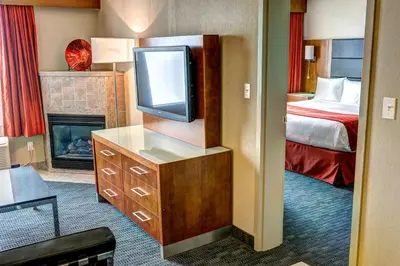 a hotel room with a television and a bed at Radisson Hotel & Suites Fort McMurray in Fort McMurray