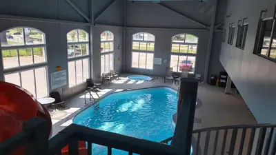 a large swimming pool in a building with windows at Radisson Hotel & Suites Fort McMurray in Fort McMurray