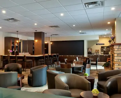 a large room with chairs and a tables and chairs at Clearwater Suite Hotel in Fort McMurray
