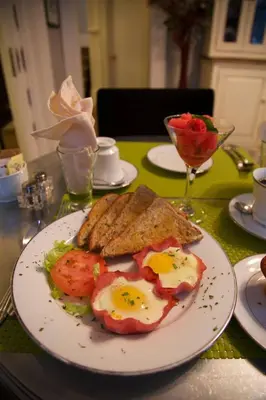 a plate of food with eggs and toast on a table at Barclay House Bed and Breakfast in Vancouver